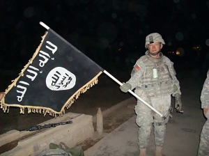 U.S._Army_soldier_with_captured_ISIS_flag_in_Iraq,_December_2010.jpg